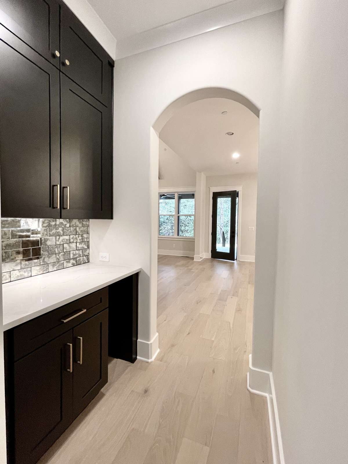 The butler's pantry is a study in efficiency, w/ every inch of space meticulously planned & optimized for functionality. Floor-to-ceiling cabinetry provides ample storage, ensuring that everything is close at hand when needed.