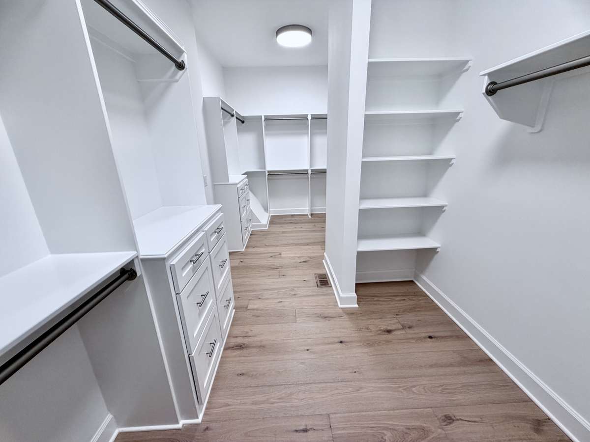 Enter your primary walk-in closet & behold the abundance of space that awaits you. With ample room for clothing, shoes, accessories, & more, discover a new level of luxury that elevates your daily routine to extraordinary heights.