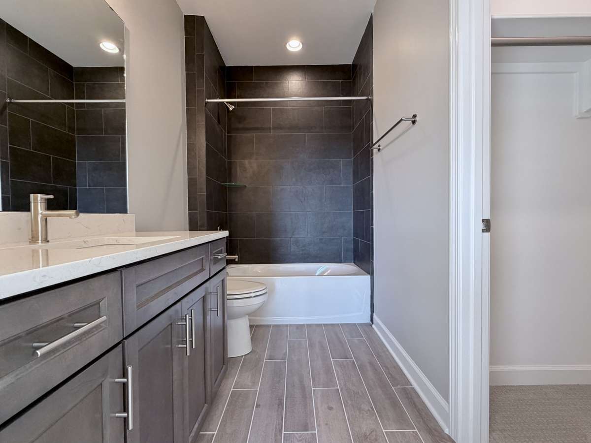 The private en suite bath is a luxurious extension of the bedroom retreat, designed to offer comfort, style, and complete privacy.