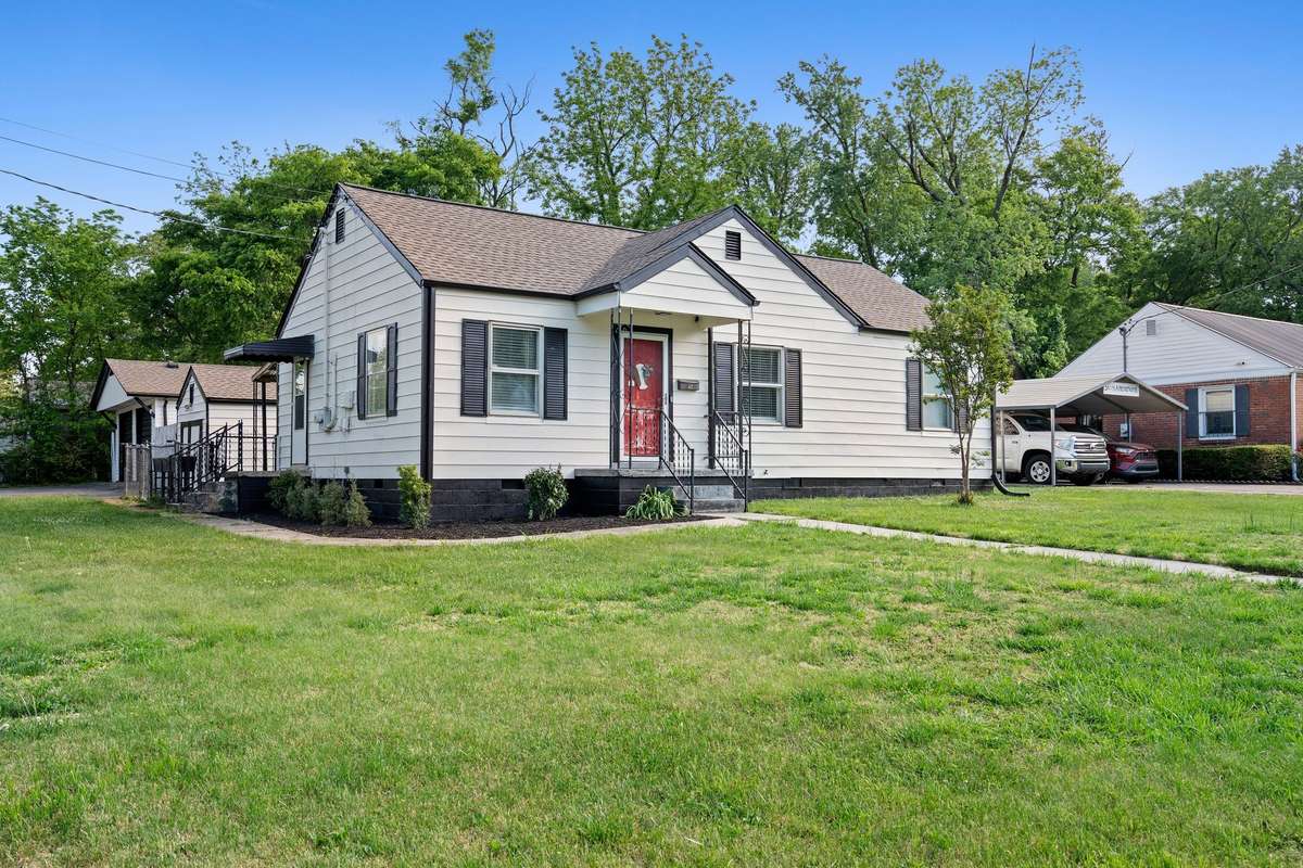 Spacious front yard with a detached garage and storage building offering plenty of storage and parking!