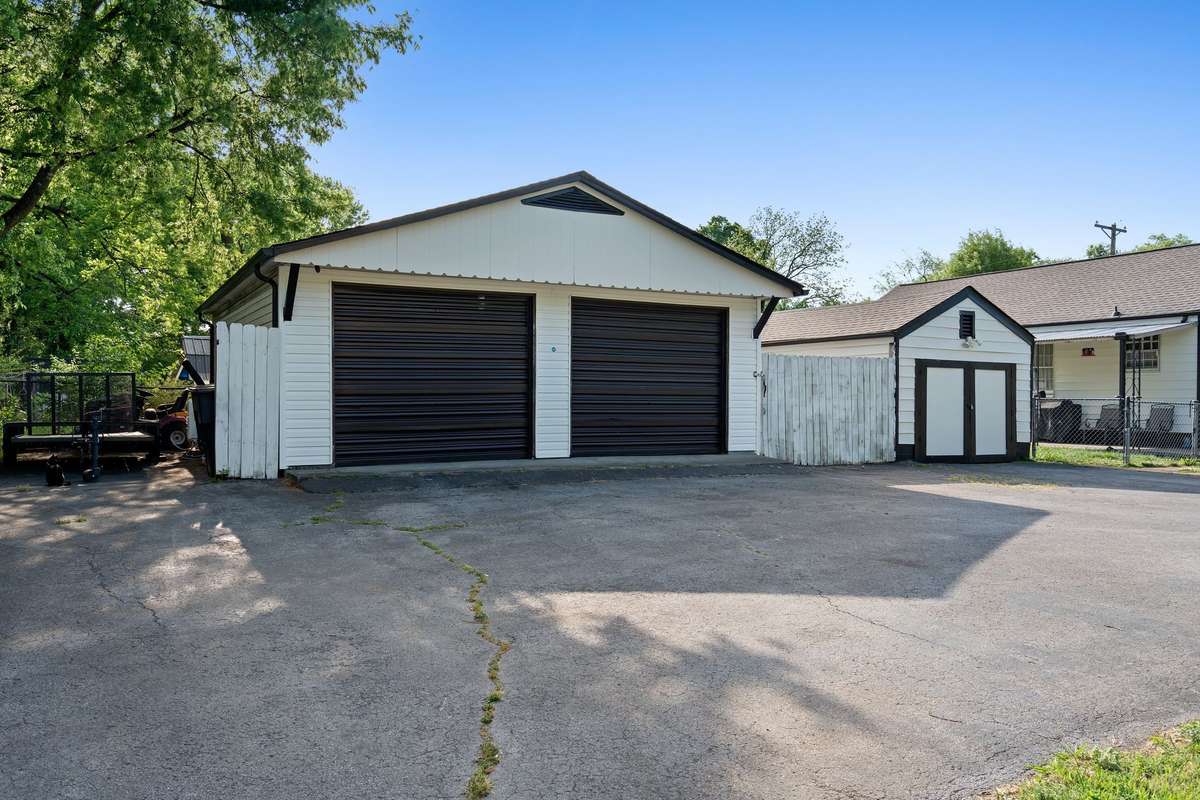 Detached 3 car garage with extended paved parking area! Storage building is big enough to fit a car.
