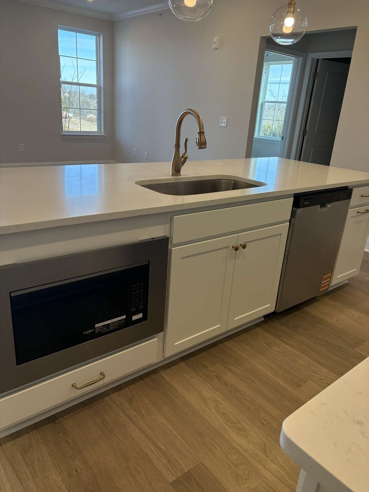 Large island included with quartz counter with microwave and dishwasher