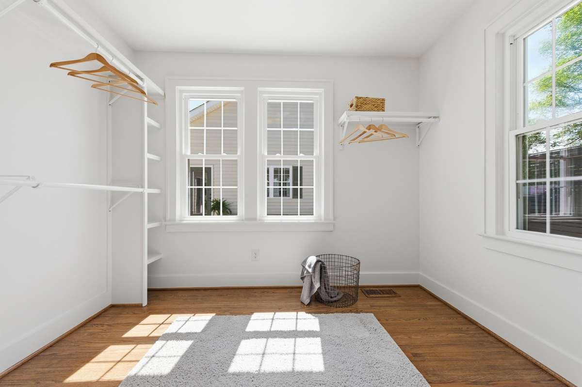 Primary Closet with Hardwood Floors and Abundance of Natural Light