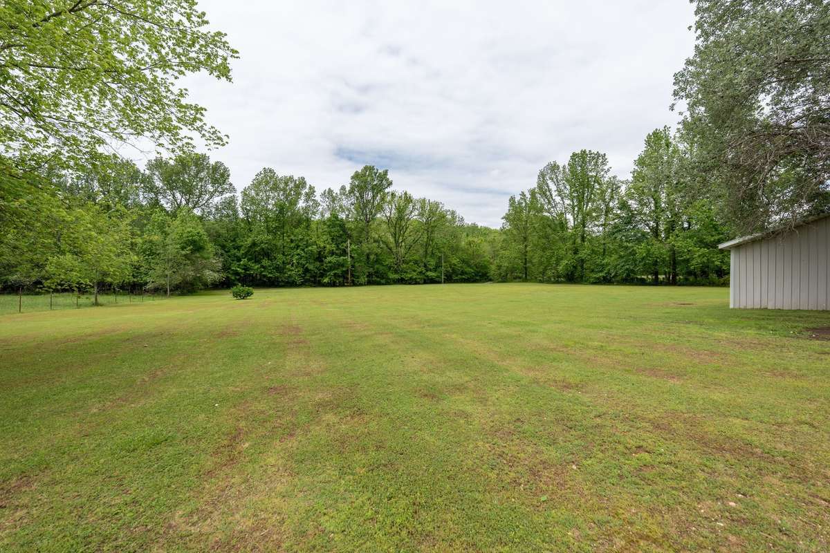 Large level lot with additional septic system and power is ran to back of property.