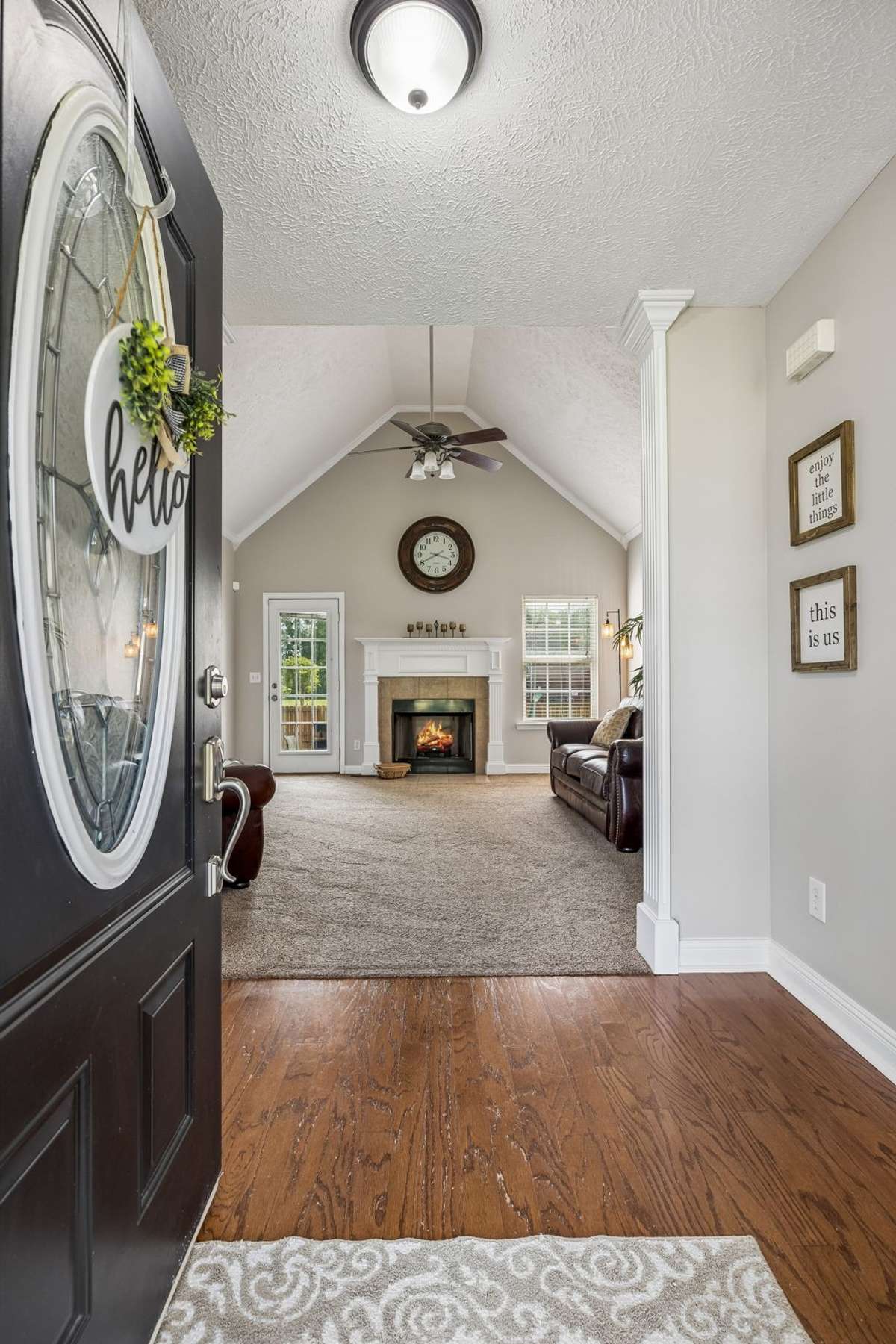 Entry opens into a vaulted living room with fireplace.