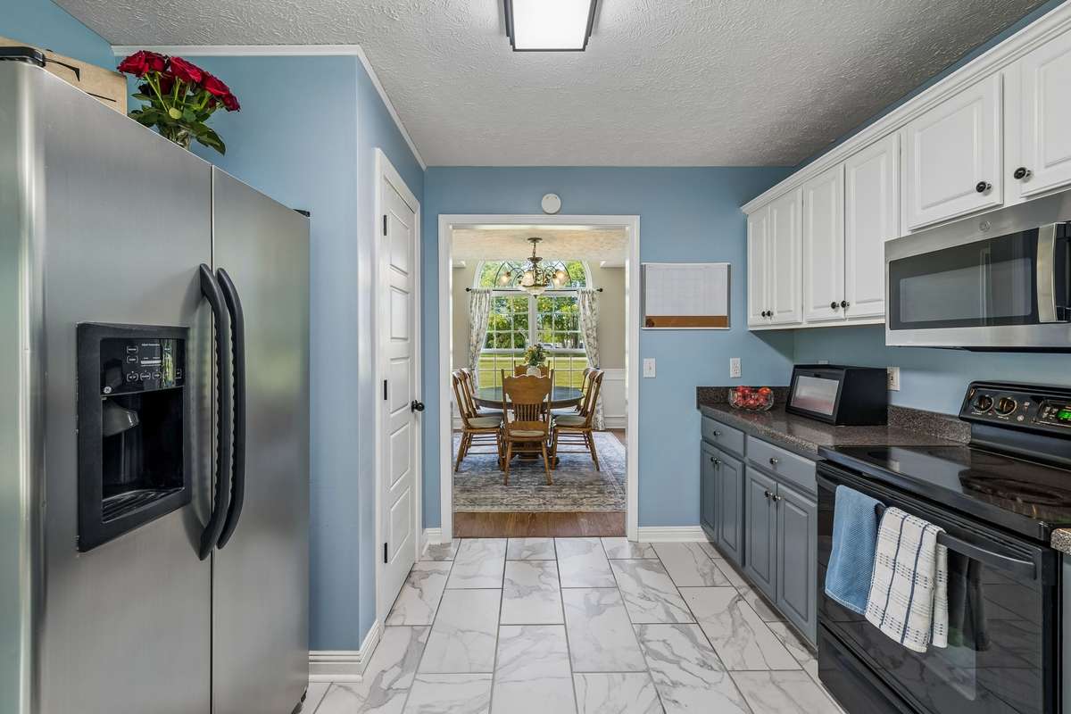 Functional kitchen with stainless appliances and bar seating.
