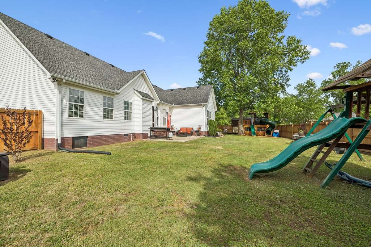 Rear exterior view with patio and fenced yard.