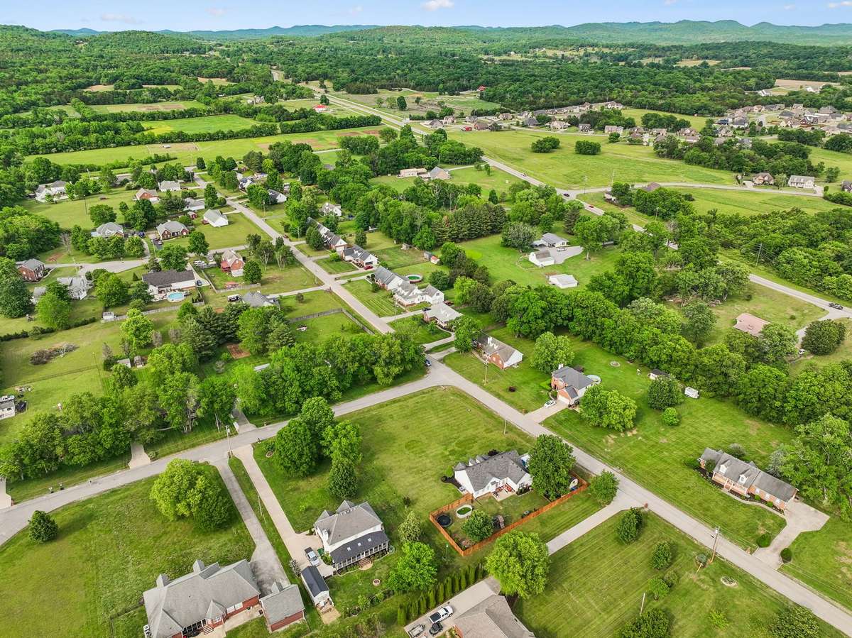 Final aerial view showcasing the home’s country-meets-neighborhood setting.