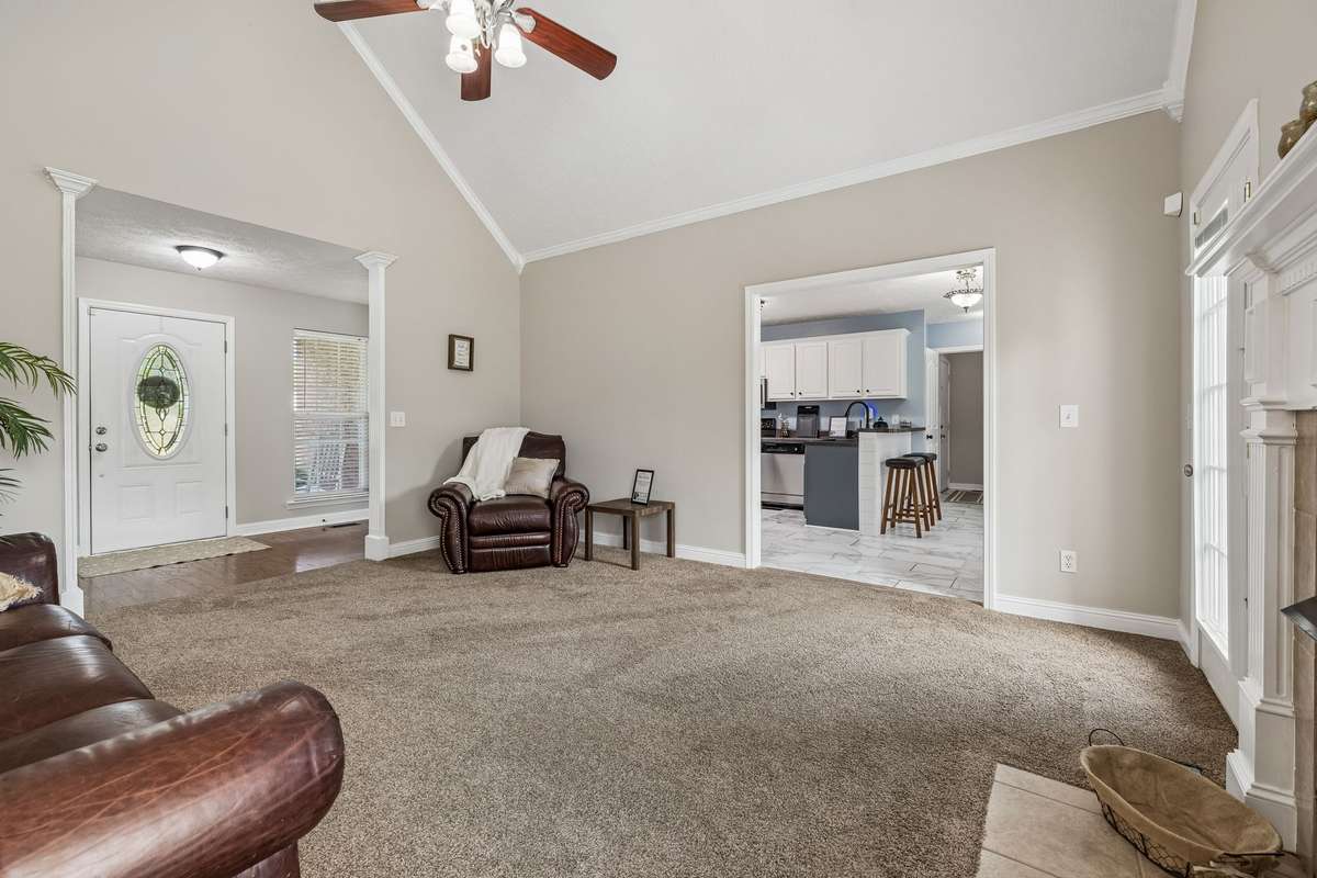 Living room view showing connection to foyer and kitchen.
