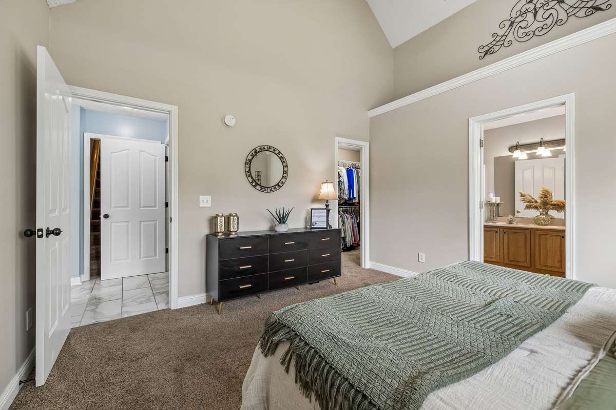 Master bedroom offers generous space, closet access, and ensuite bath.