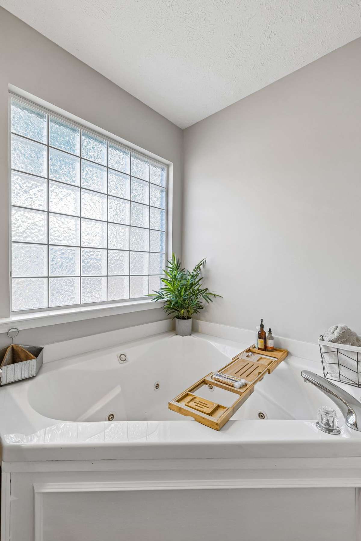 Soaking tub detail with bright, private window.
