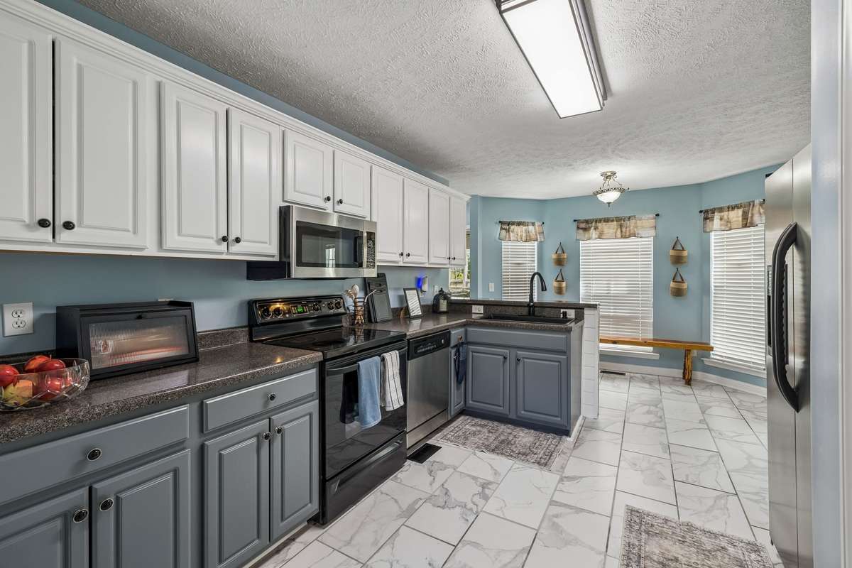 Kitchen offers plenty of cabinetry and natural light.