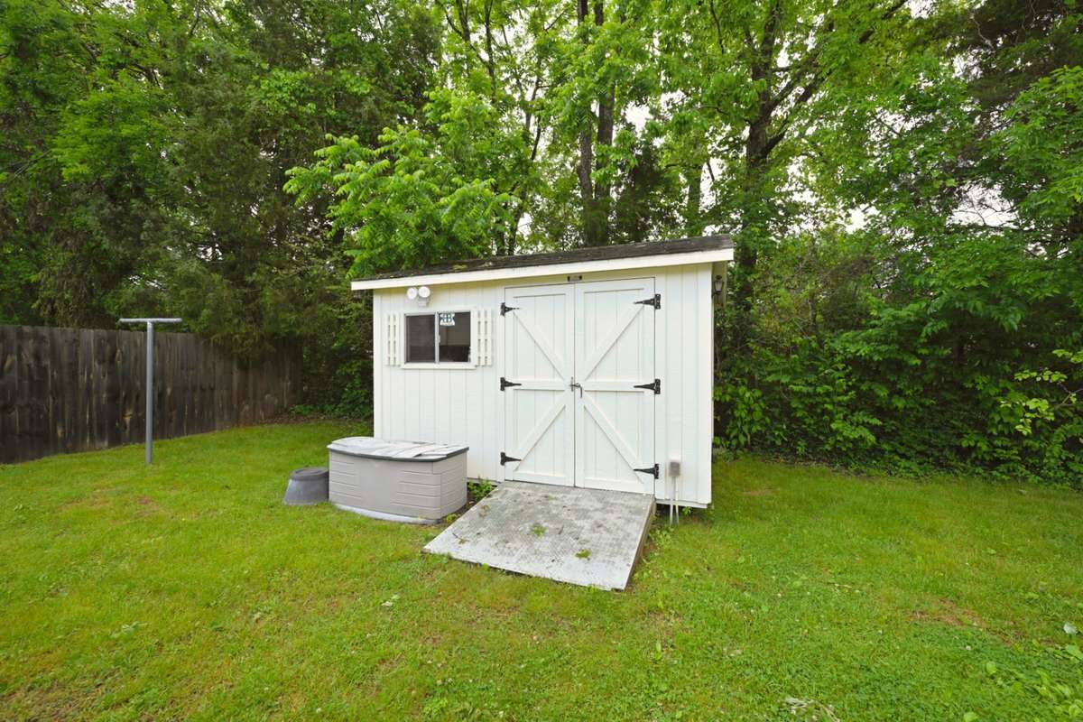cute shed offers storage for lawn and pool supplies