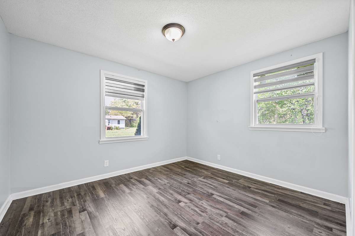 Two of three bedrooms, this one boasts two windows.