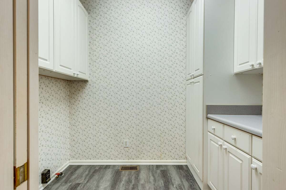 Laundry Room with Cortec Flooring and Extra Cabinetry