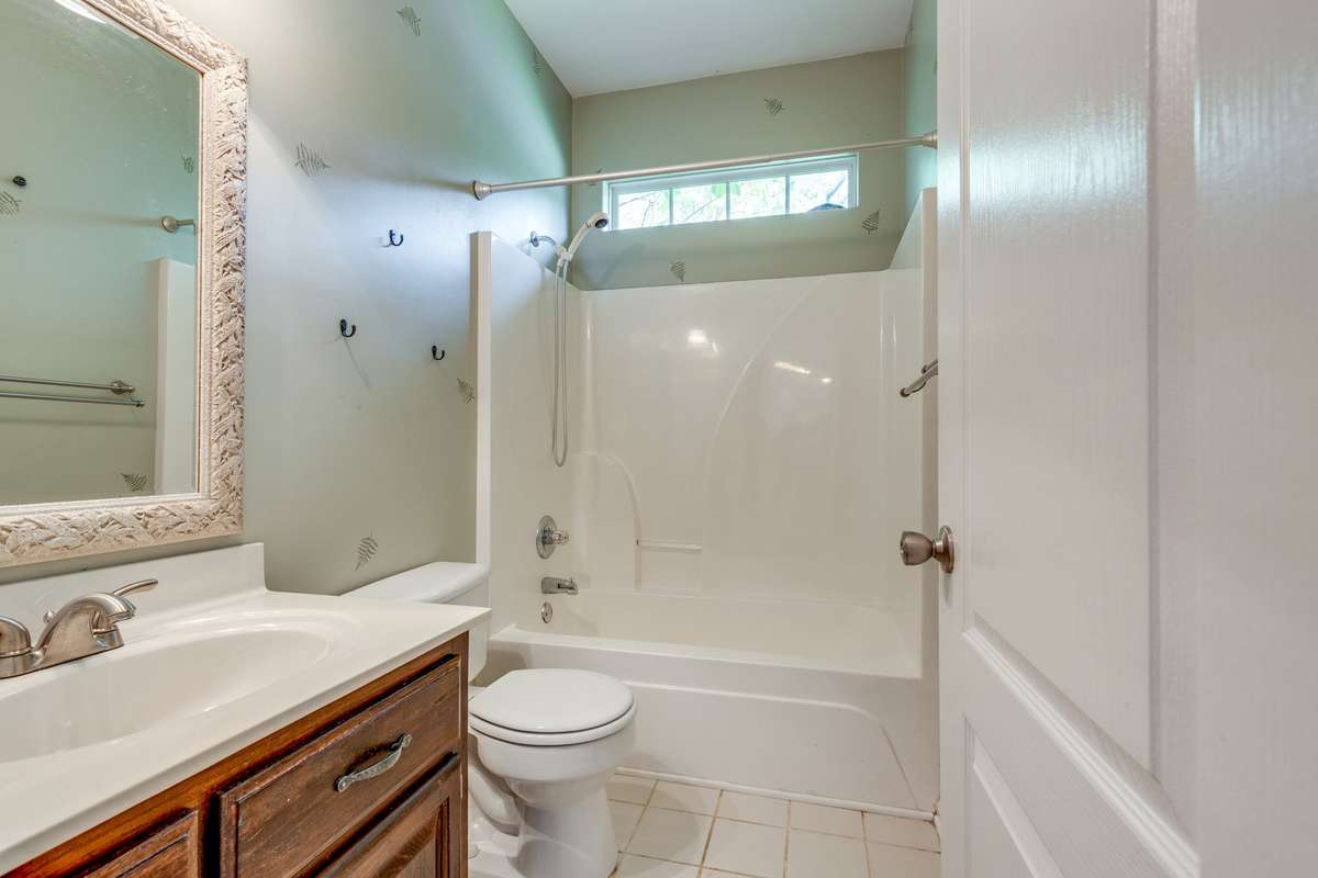 Second Bathroom with Tiled Flooring and Transom Window for extra Light