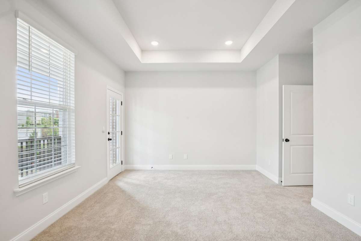 ***Photo taken from a previously built Esplanade townhouse. Professional photos coming soon for this property.***

Primary Bedroom