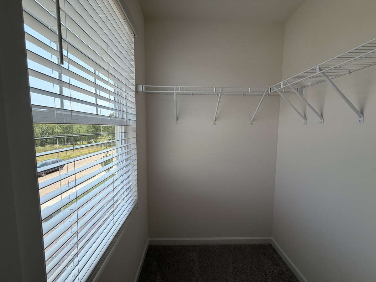 Bedroom 2's closet with a window