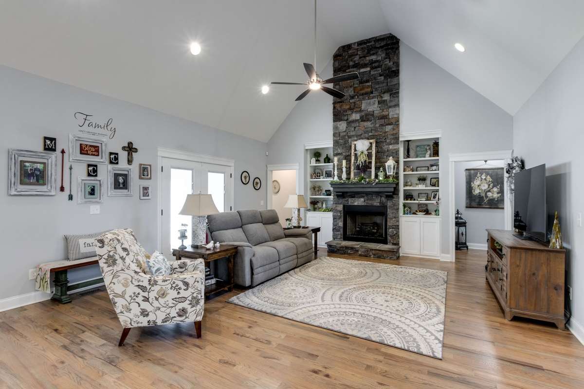 Large living room with fireplace spanning to the ceiling