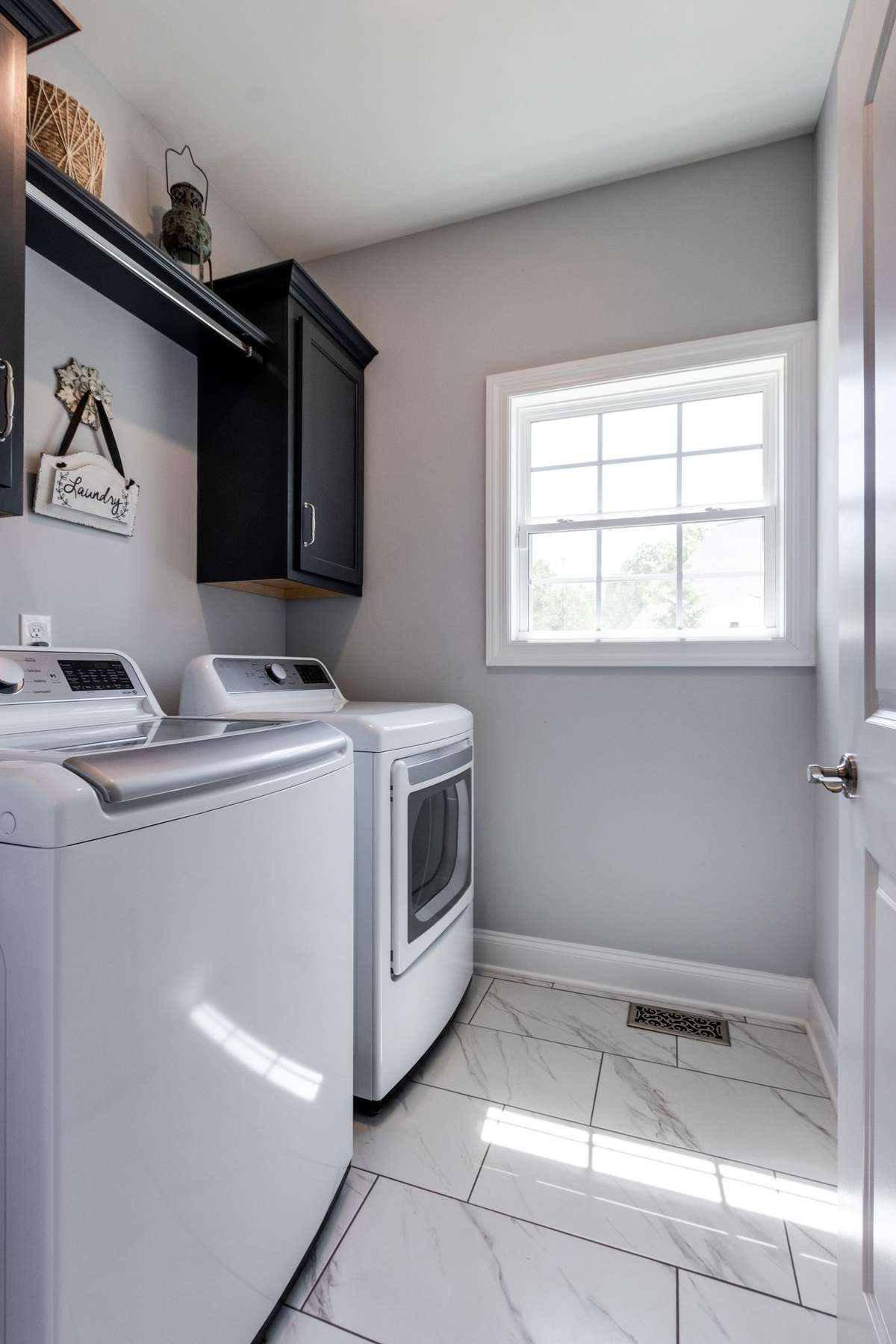 Laundry room with built in cabinets and hanging rod!