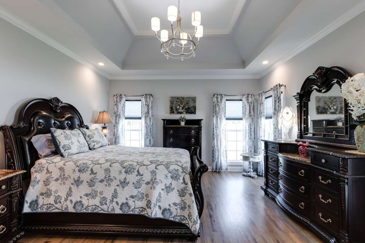 Primary bedroom with double trey ceiling and crown molding