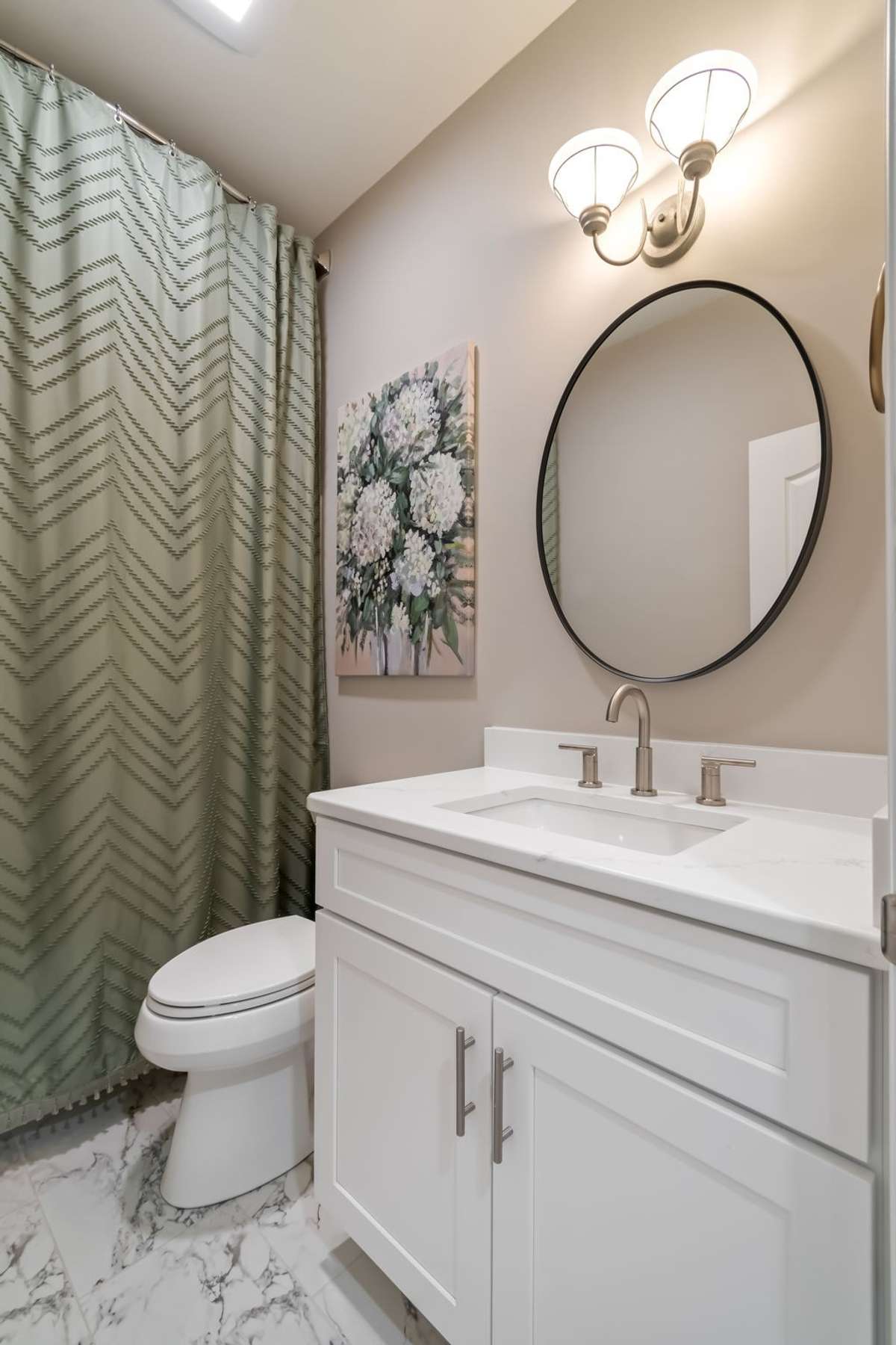 upstairs full bath at end of hallway
