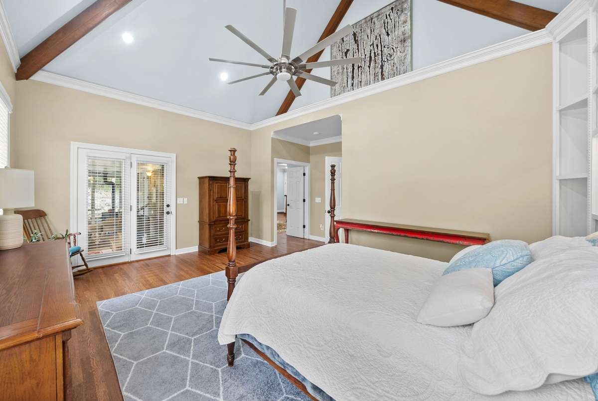 Primary bedroom with soaring ceilings and access to sunroom