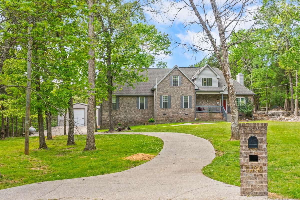 Wonderful concrete drive leads to a 2-car garage - shop and lots of parking in the back