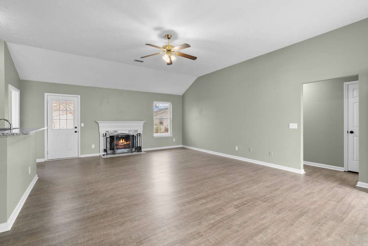 A wood-burning fireplace with a marble surround and trim-carpentered dental-mold mantel
adds timeless character.