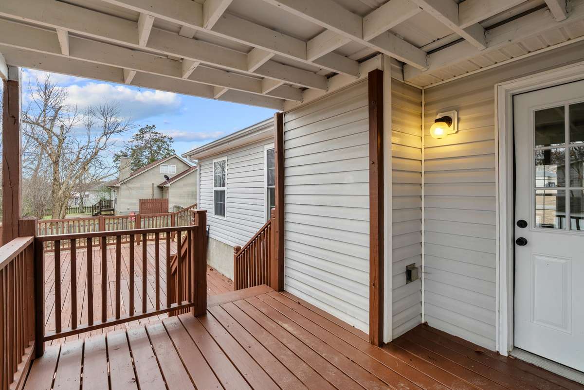 From the family room, step onto the covered deck—a perfect extension of the home’s living space.