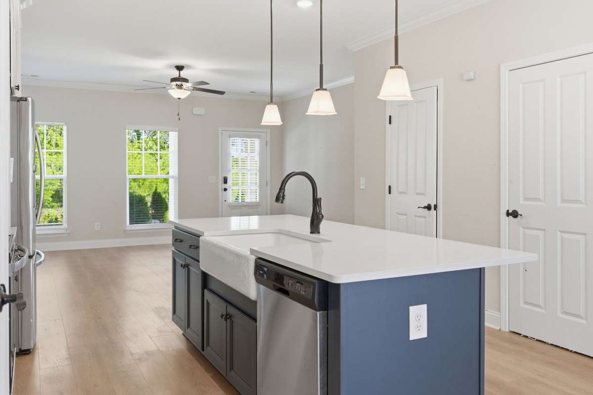 Kitchen with pantry and upgraded finishes. Stainless-steel refrigerator stays with the home.
