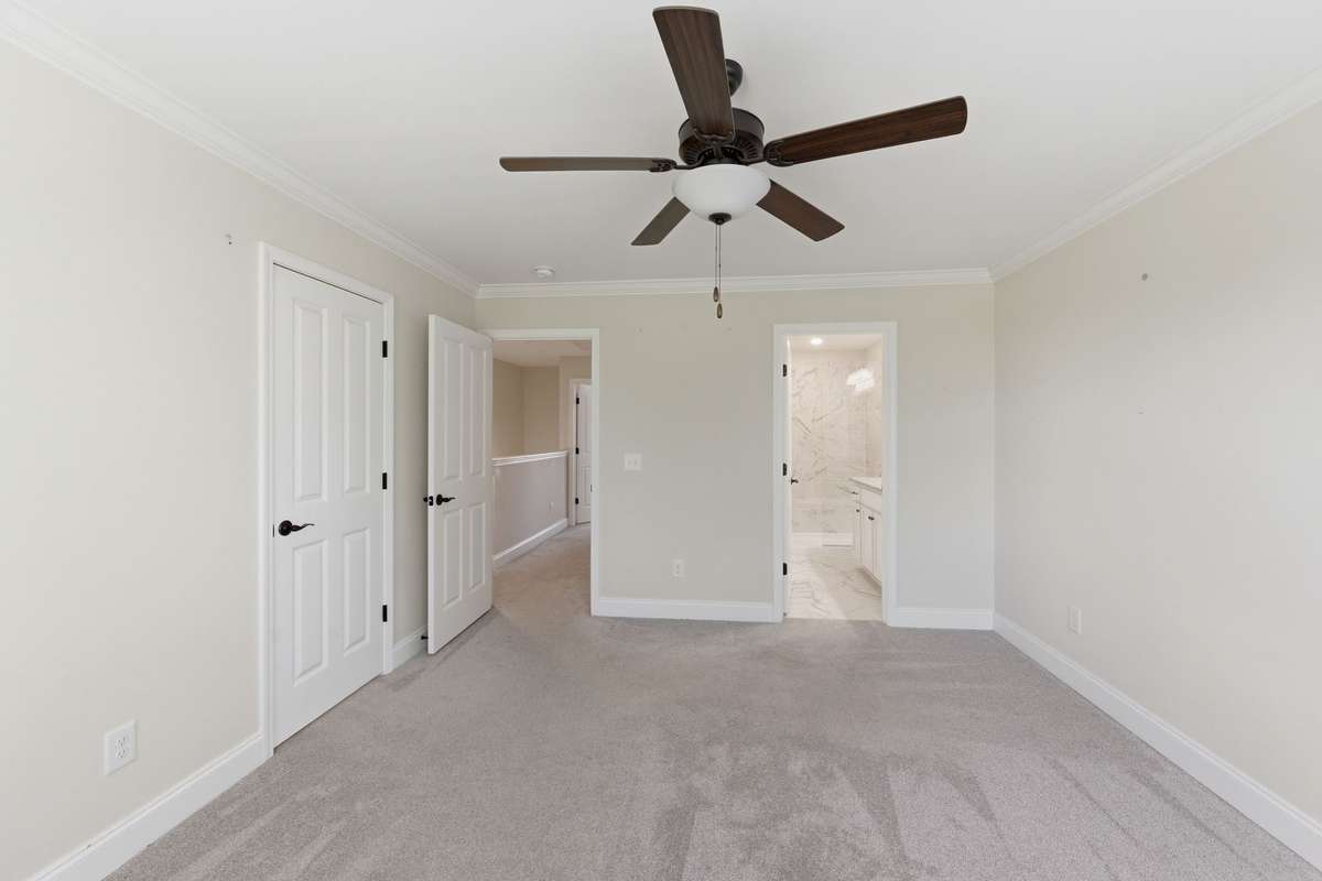 Primary bedroom with two walk-in closets and ensuite bath