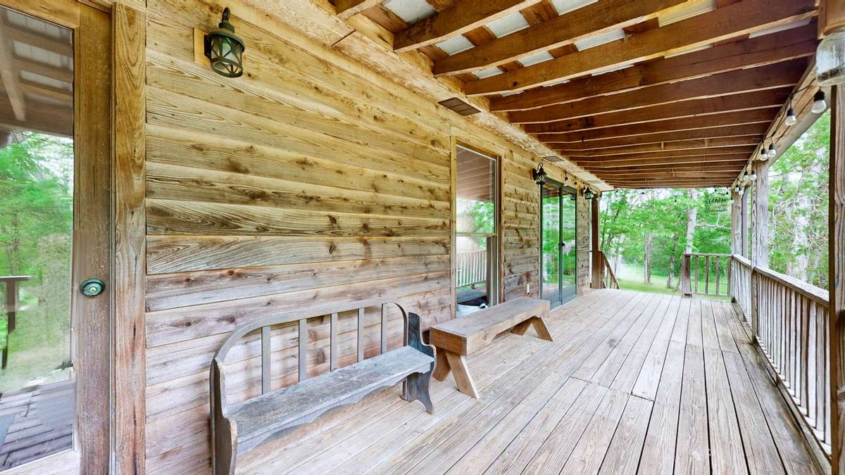 Back portion of the wrap around porch.  The living room, primary bedroom and sunroom all open up to this area of the porch