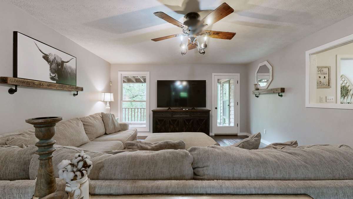 Living room on main level that opens to the back porch