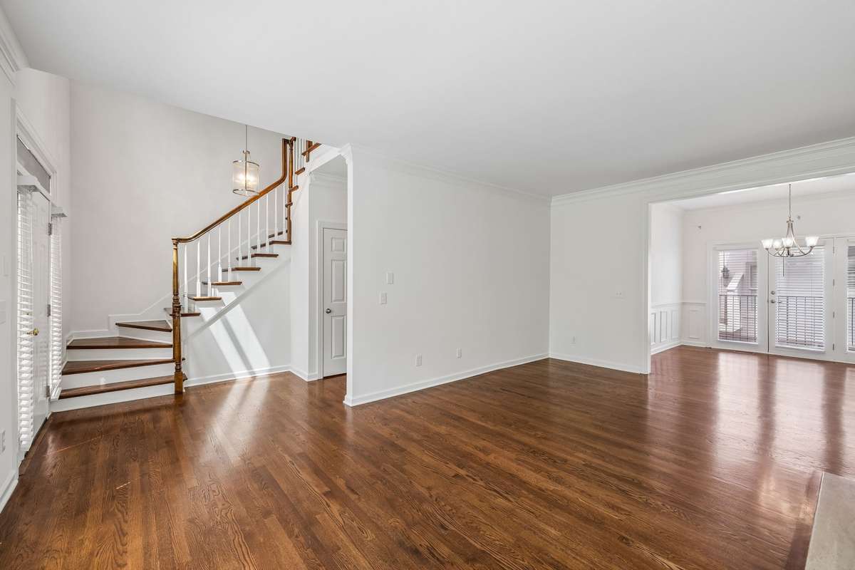 Elegant staircase leads to bedrooms on second floor.