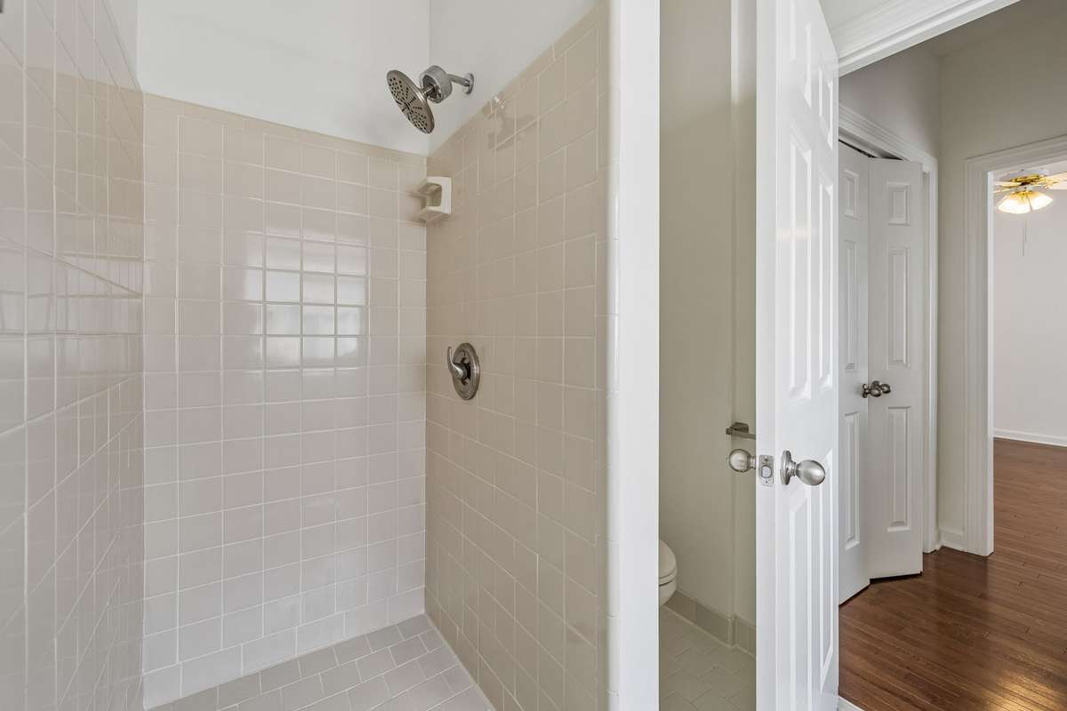 Separate tub and large shower adjoin the primary bedroom.