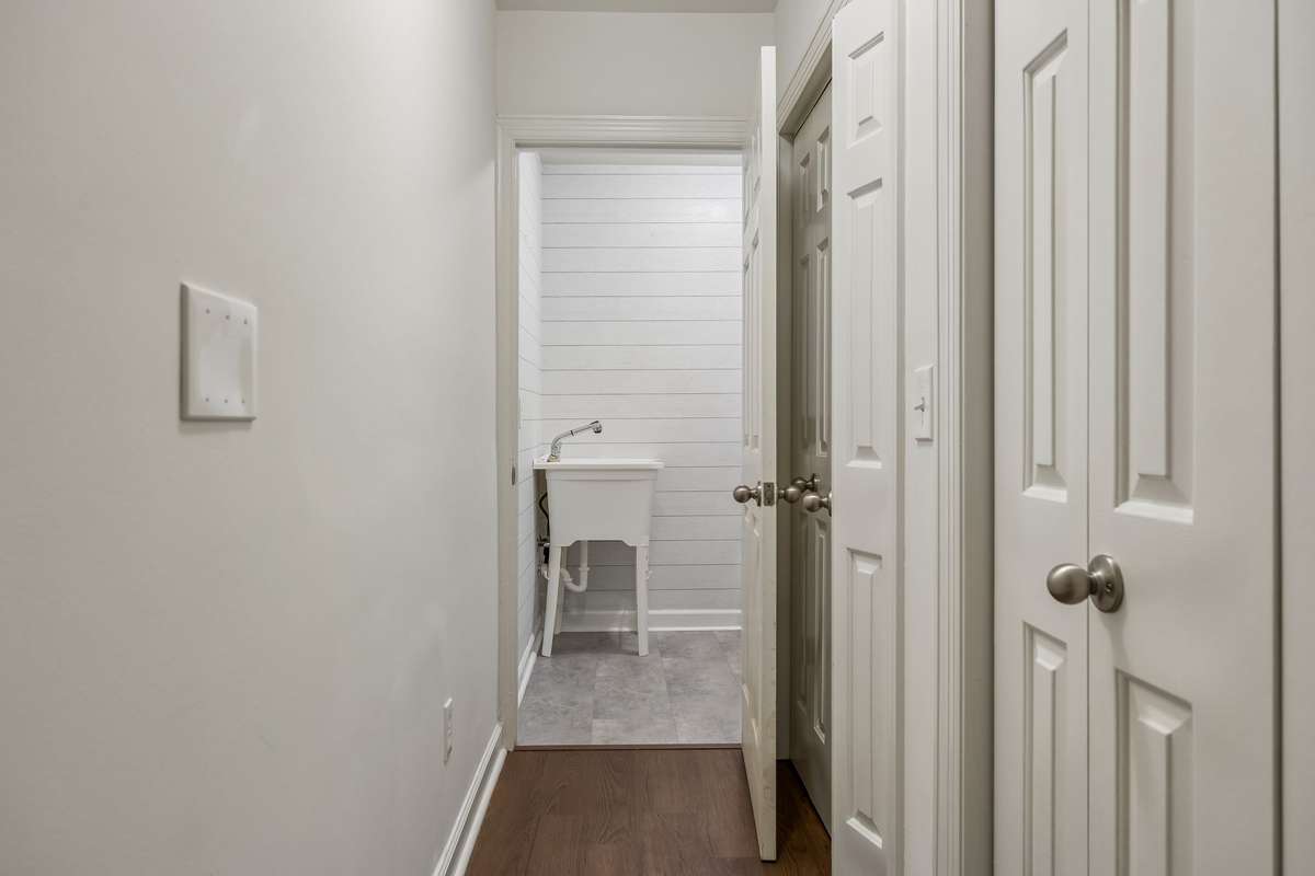 Extra large storage closets in the basement just off the garage.  Hallway leading to laundry room complete with sink!