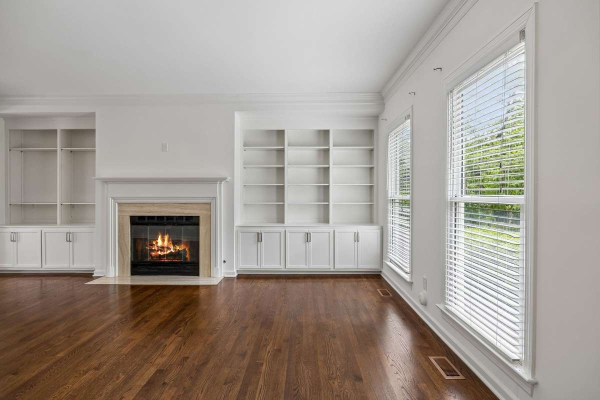 This lovely family room features built in shelves and fireplace.  It opens to dining room area for that open plan feeling.