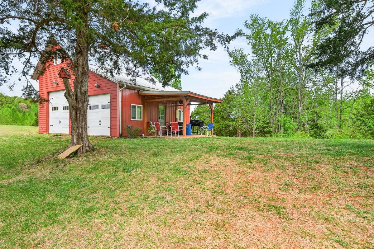 Rcreational barn with 2 role up doors, covered porch for relaxing and visiting.
