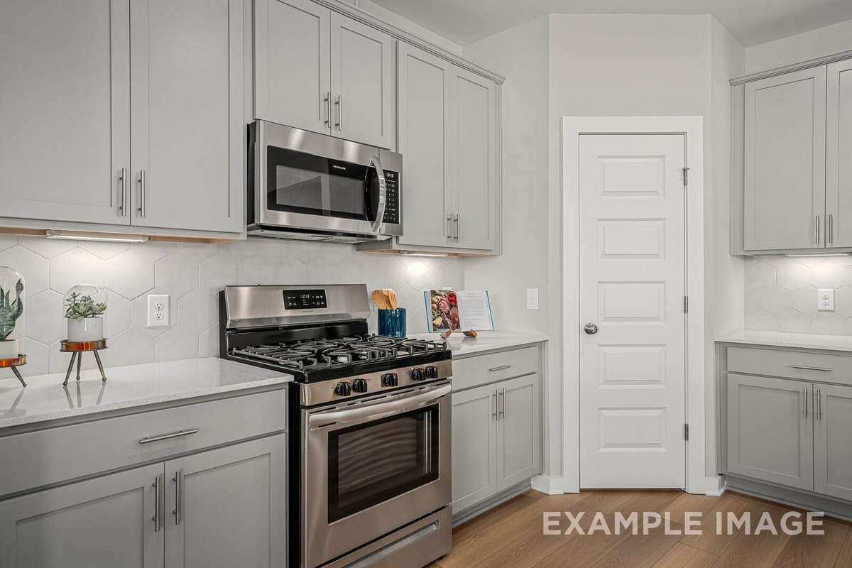 Picture of actual home being sold.  Furniture is being removed, but curtains and appliances are being sold with home