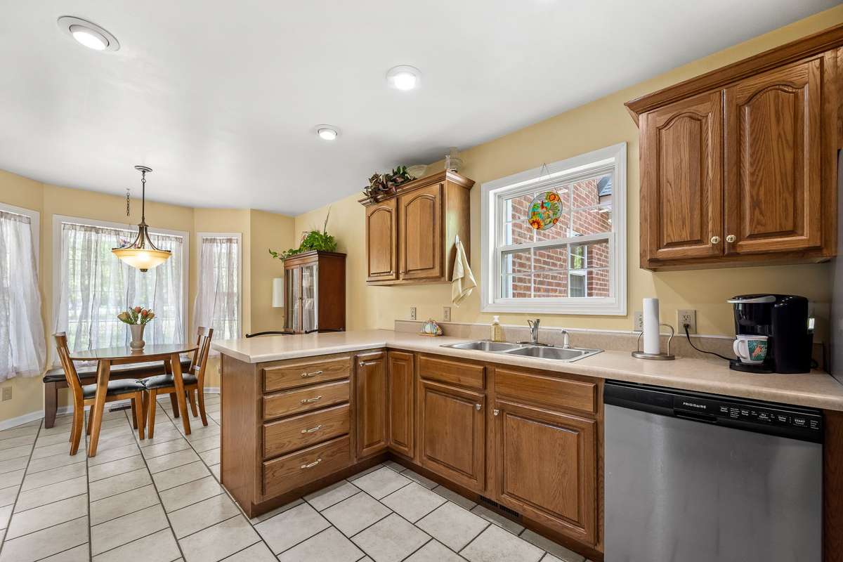 Sink in Kitchen has window to look out into the yard.