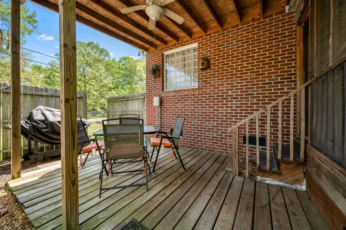 Covered deck next to screened in porch.