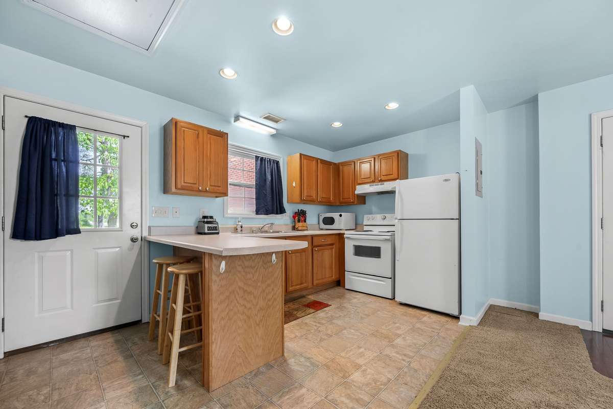 Kitchen with eat-in bar.  Also has a backdoor to come in from the back parking area.