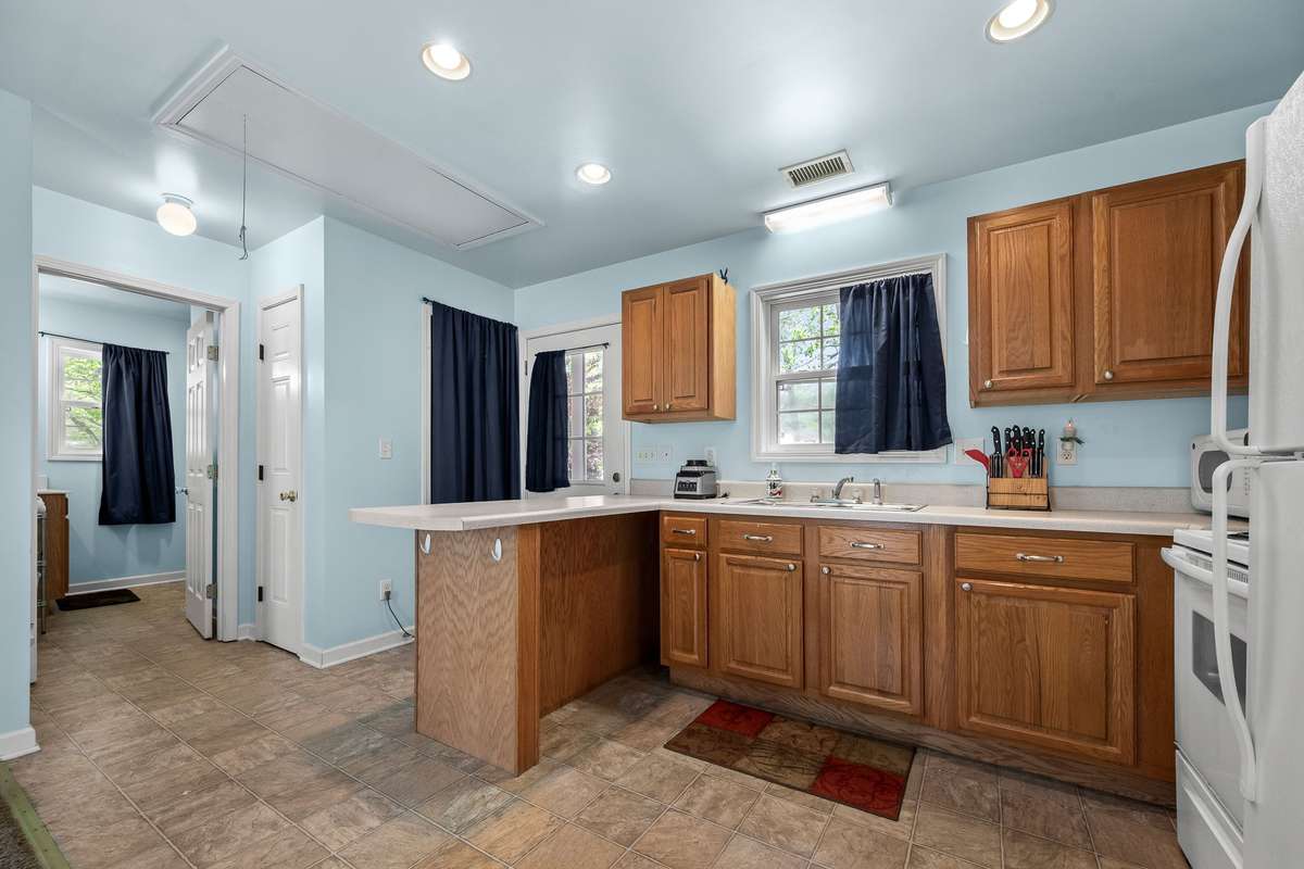 Kitchen has vinyl flooring.
