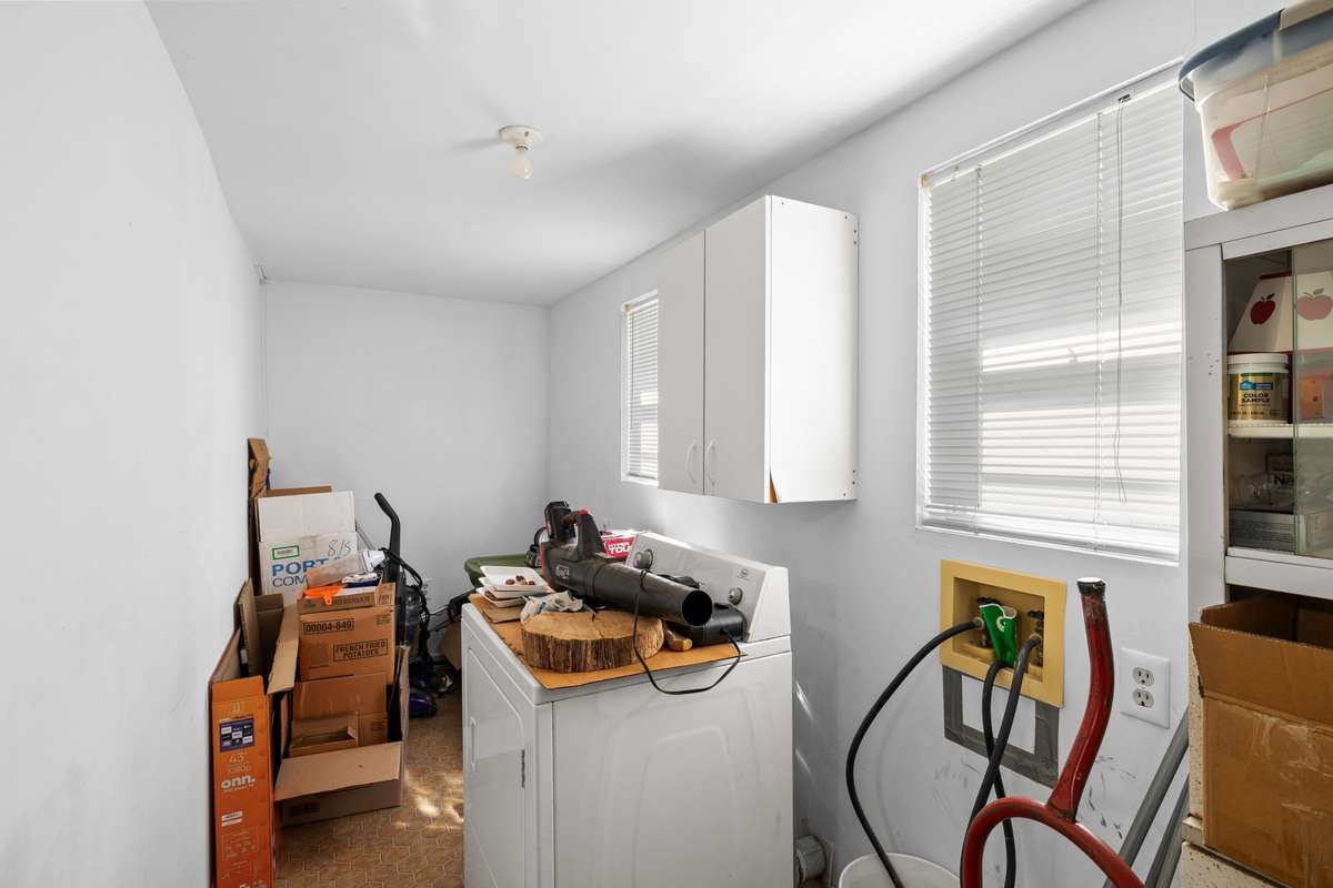 Large laundry room with separate mud room. Dryer remains