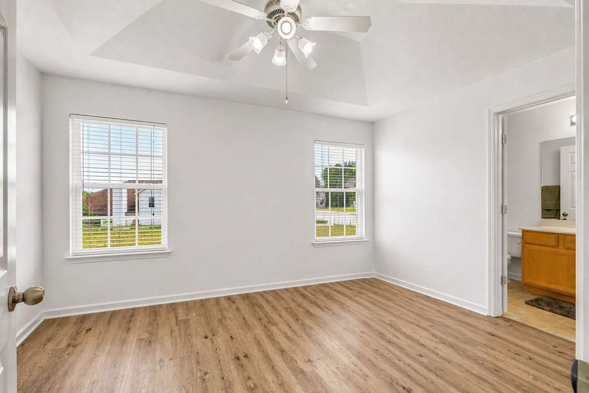 Spacious second bedroom suite with LVP flooring. Moving boxes removed from photo.