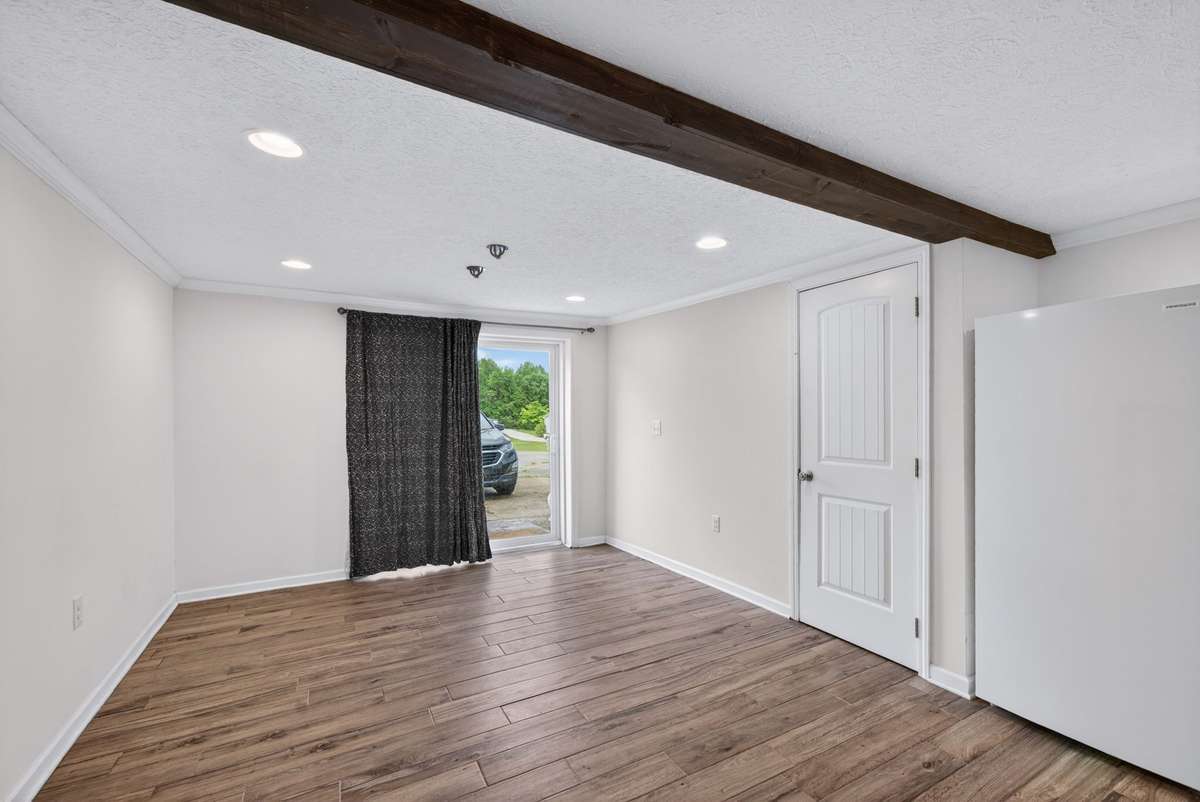 basement level with sliding door leading outside and pedestrian door leading to single car garage