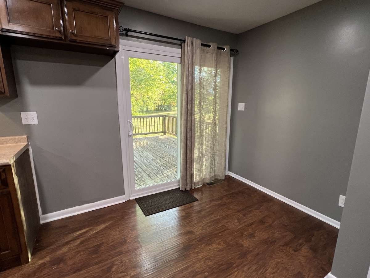 This sliding glass door is more like portal into another world. With acres of trees and flat land, you will experience country living like no other by simply sliding this door open!