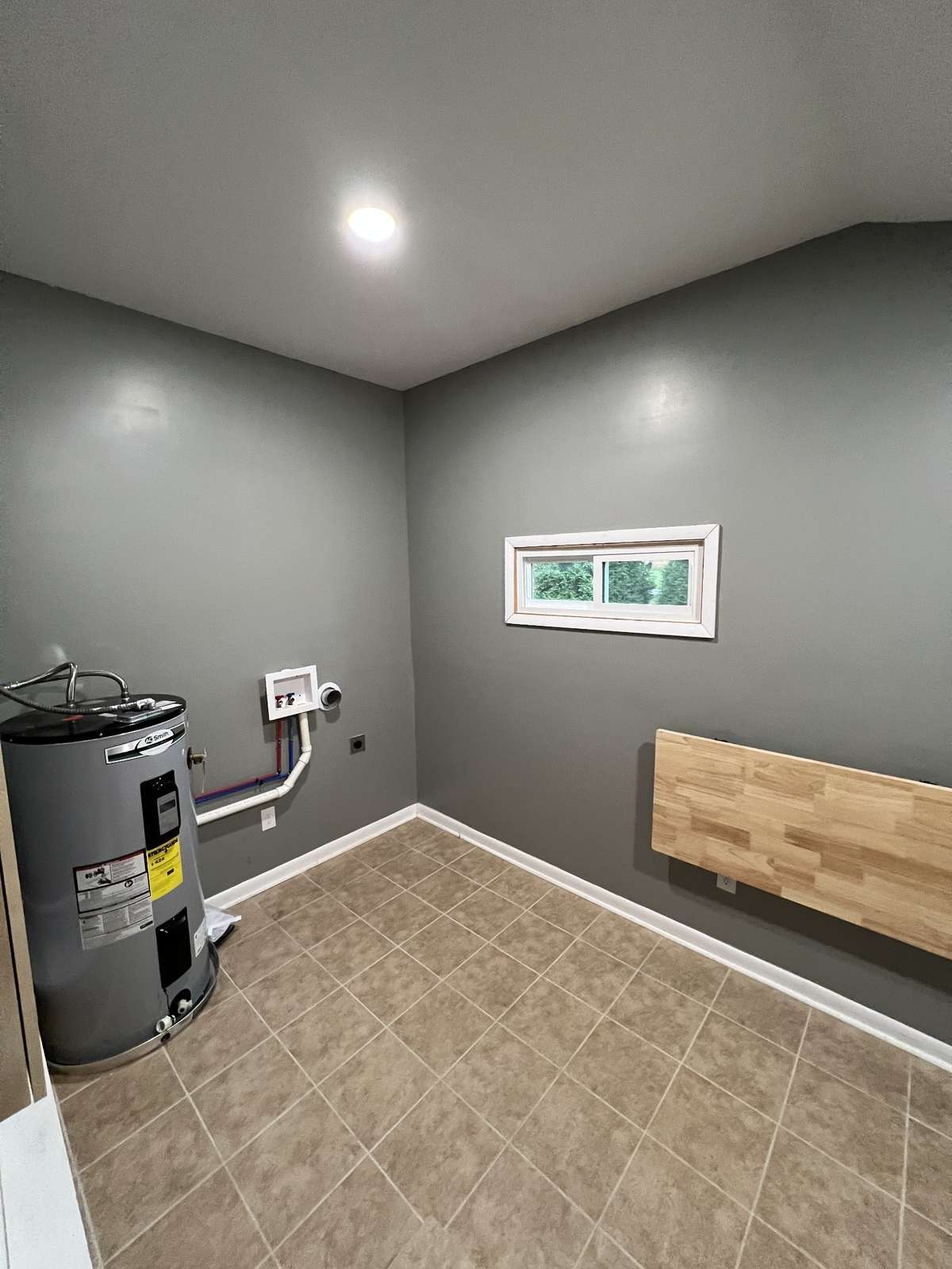 A nice large area for the washer and dryer next to your water heater.