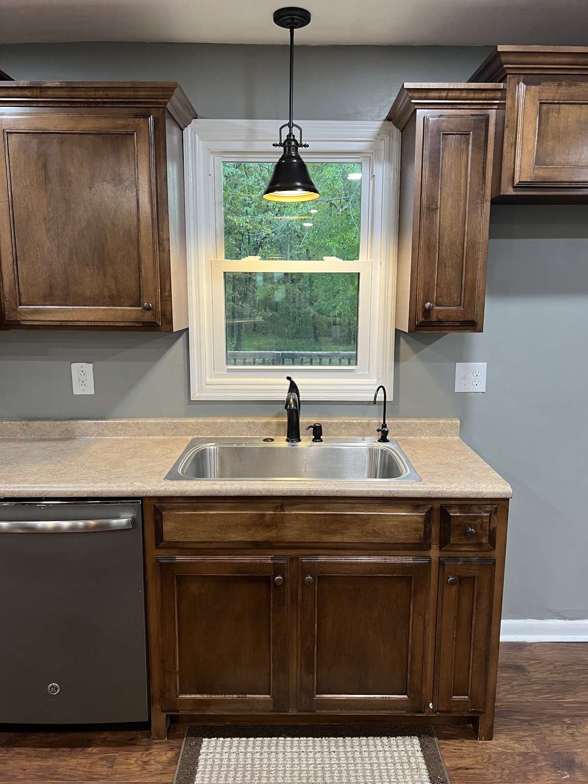 To some this just looks like a sink, but to others you will see a large single basin stainless steel sink complete with a garbage disposal system, a soap dispenser, and filtered drinking water faucet!